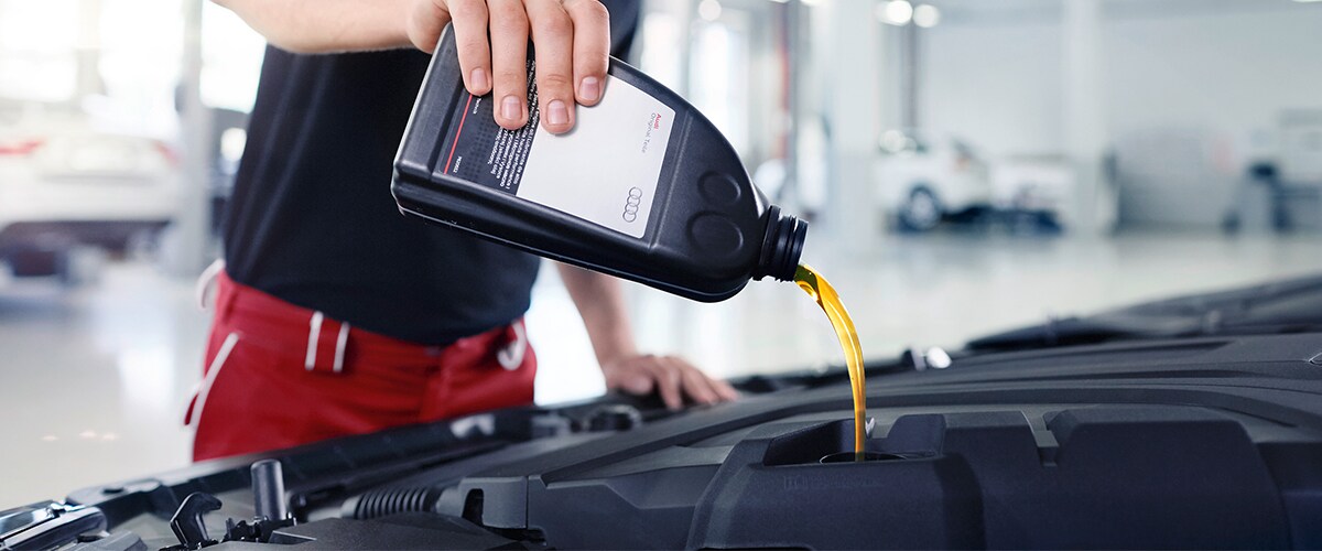 A Service Technician at Audi Pensacola Performing an Oil Change in Pensacola, FL