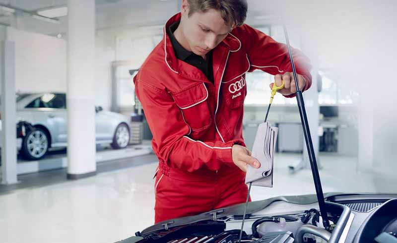 Audi Technician checking oil