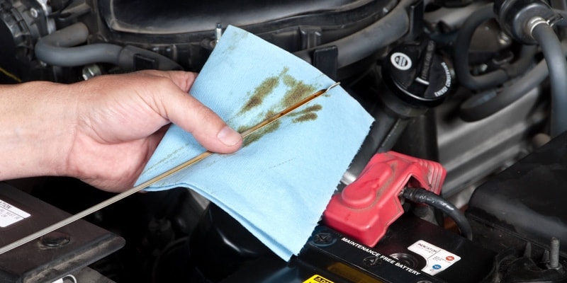 Auto Mechanic Checking Oil