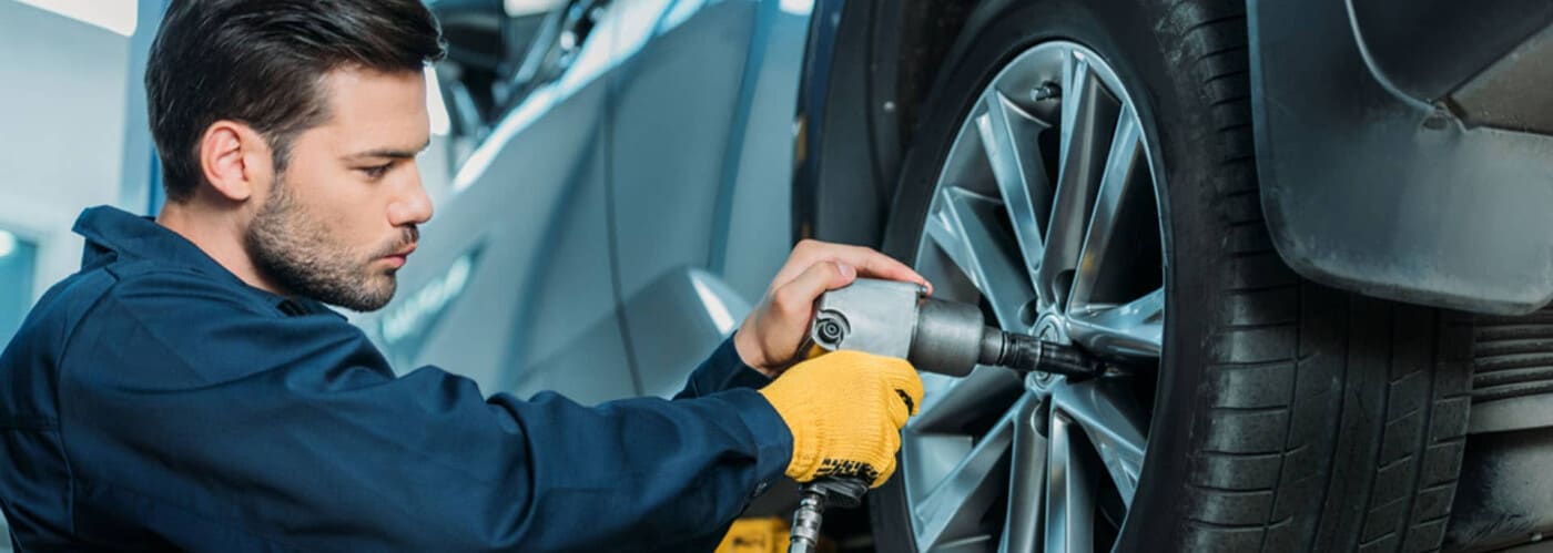 Technician Working on Auto Tires