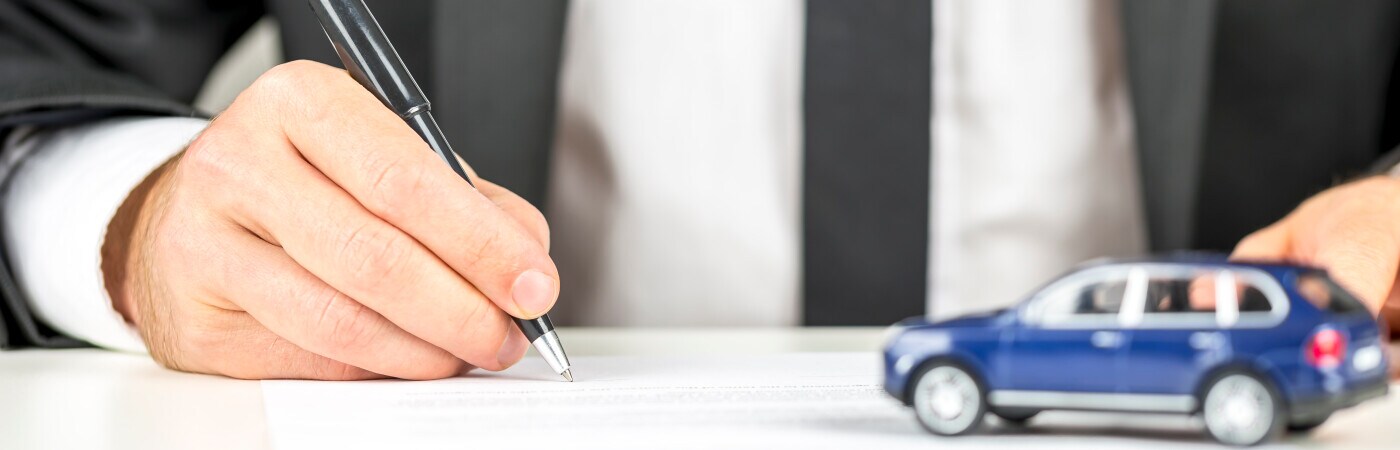 Man Signing Car Insurance Documents