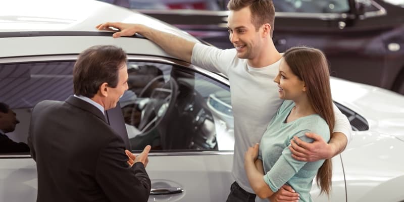 Car Salesman Speaking with Couple