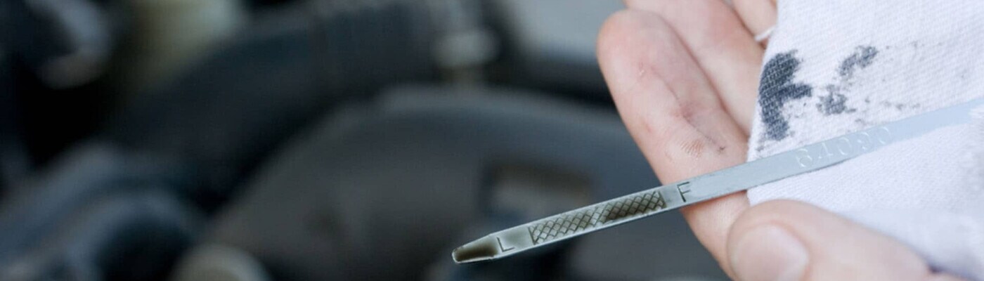 checking oil on a dipstick