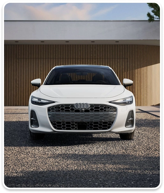 Front view of a white Audi A6 Sedan showing its Singleframe grille and headlights