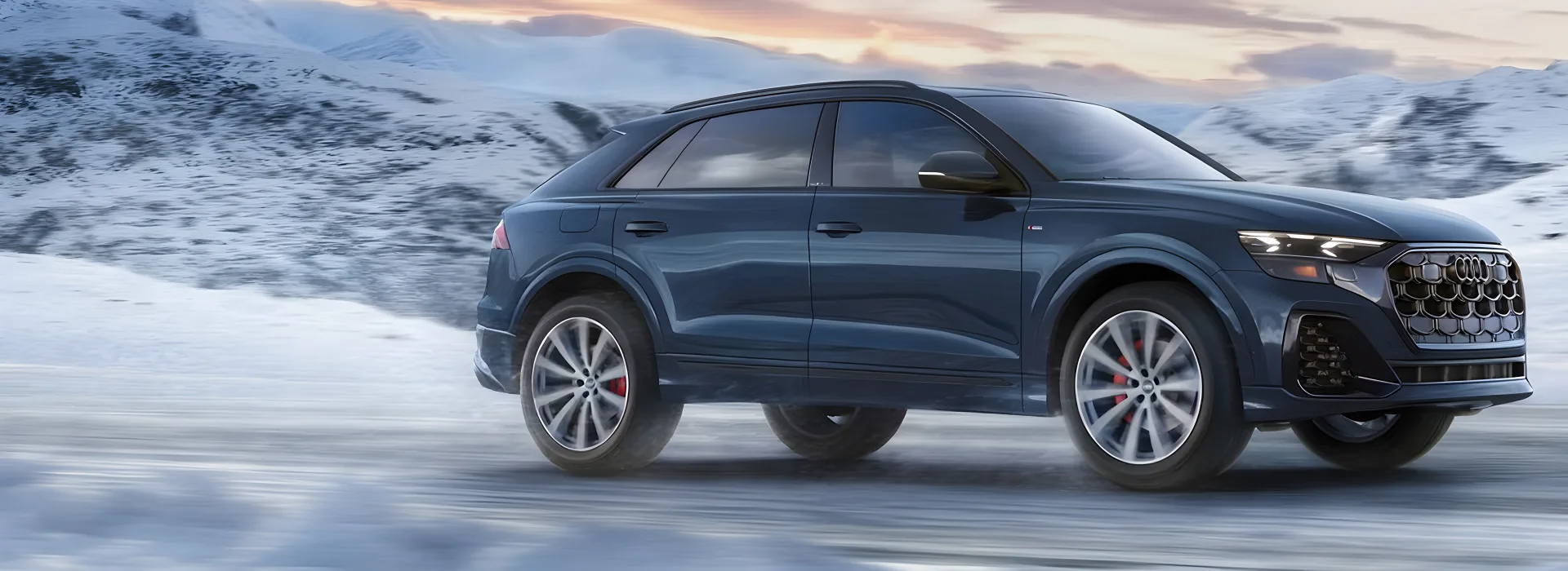 Dark blue 2027 Audi Q8 parked on a snow-dusted plain at dawn, seen in profile