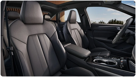 Black leather front seats of the Audi A6 Sedan seen through the open door