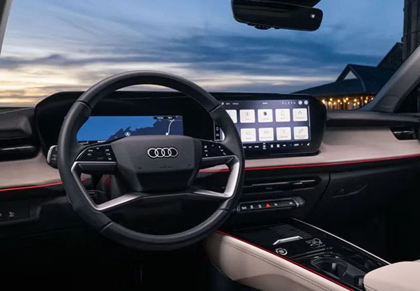 Audi Q3 cockpit at dusk showing the virtual cockpit and the wide MMI touch display