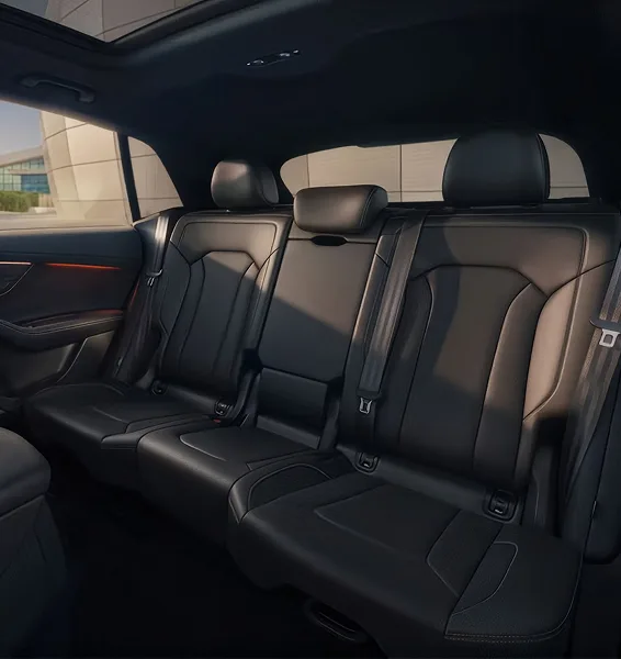 Black leather rear seats of the Audi Q8 seen through the open rear door