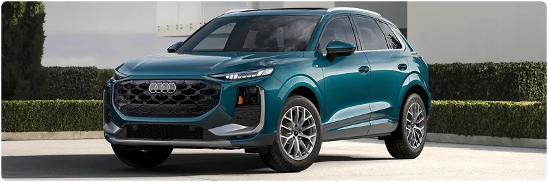 Teal Audi Q3 parked on a driveway, seen from the front three-quarter angle