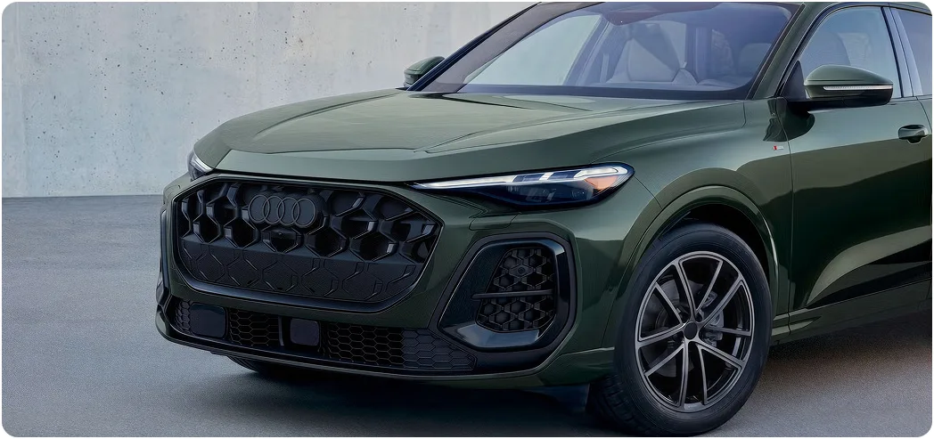 Dark green Audi Q5 with the S line black optic package, seen from the front three-quarter angle