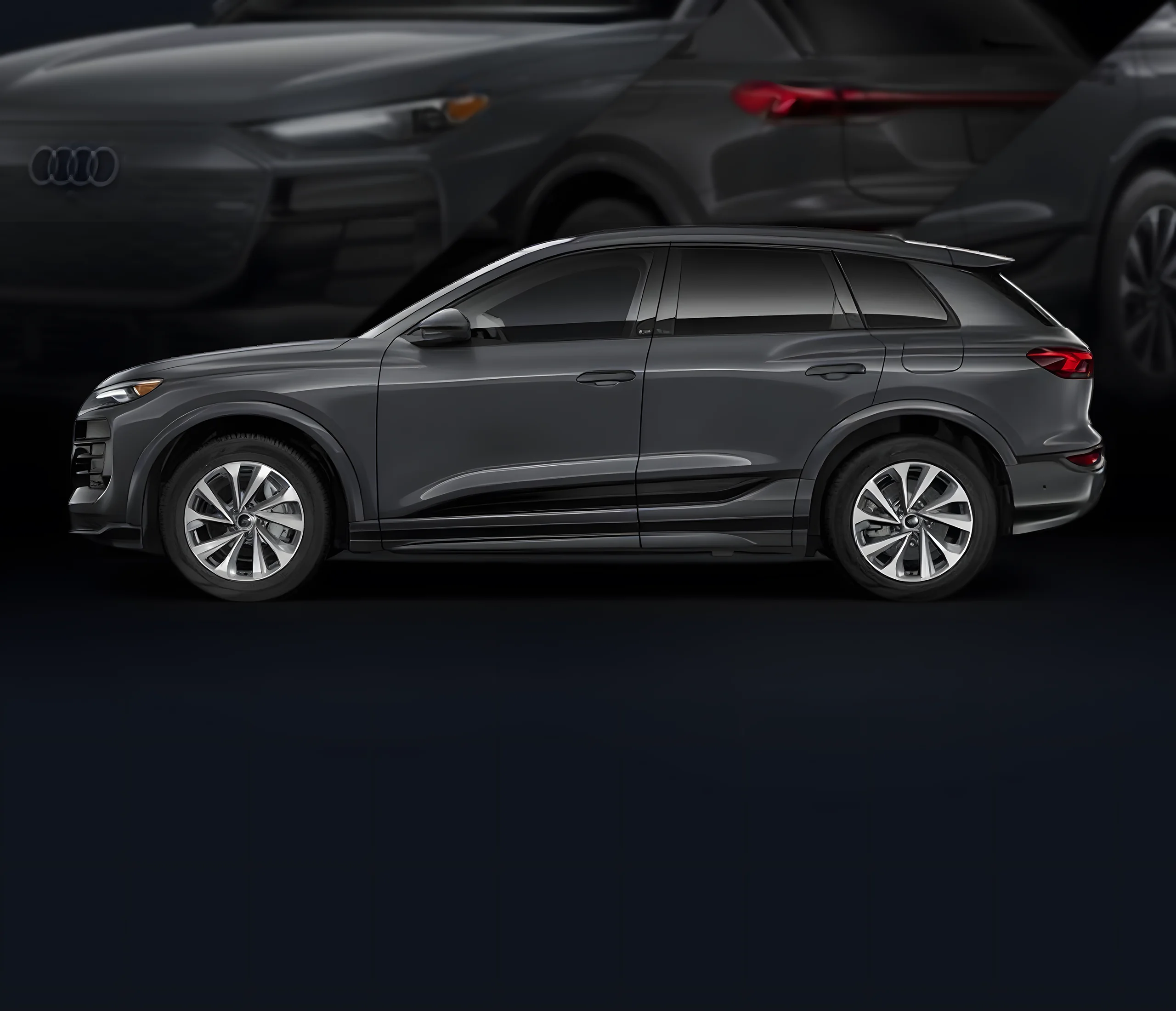 Grey 2027 Audi Q6 e-tron in profile against a dark backdrop of the same vehicle