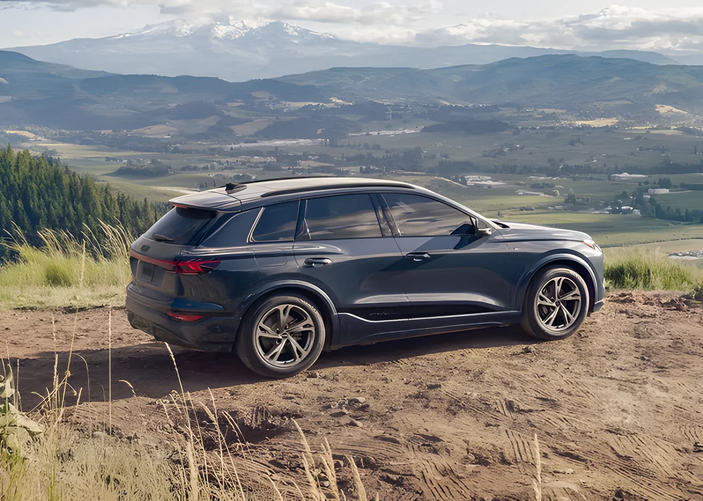 Audi Q6 e-tron parked on a hillside overlooking a valley