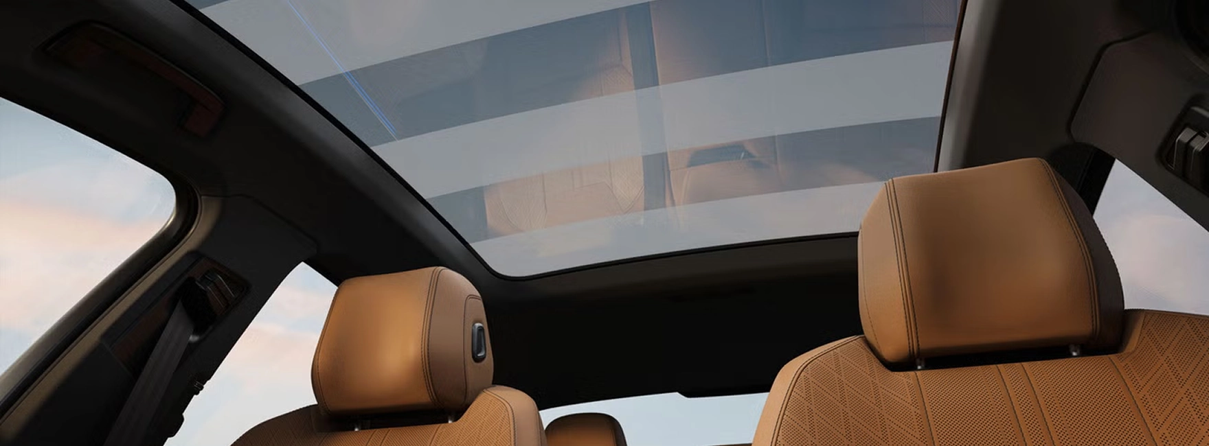 Panoramic glass roof above the brown leather seats inside the Audi A6 Sedan