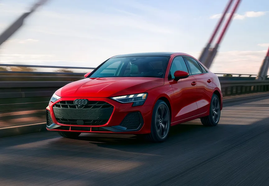 Red Audi A3 driving across a bridge