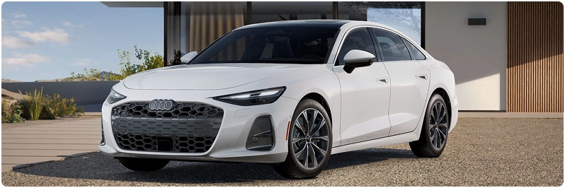 White Audi A6 Sedan parked outside a modern house, seen from the front three-quarter angle