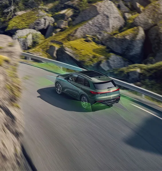 Overhead view of a green Audi Q5 on a mountain road with lane guidance markings overlaid
