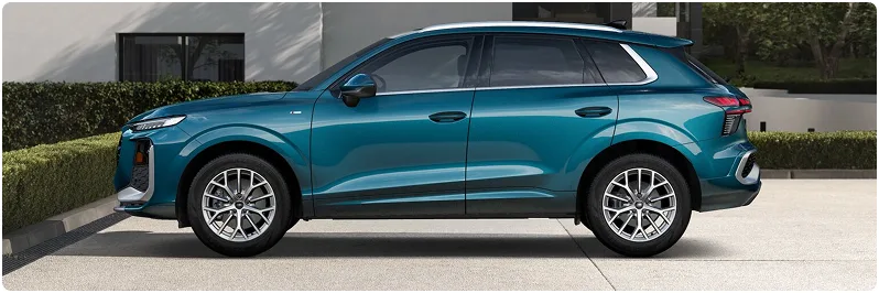 Teal Audi Q3 parked on a driveway, seen in profile