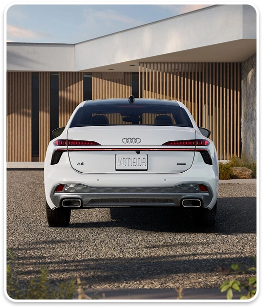 Rear view of a white Audi A6 Sedan showing its continuous LED taillight bar