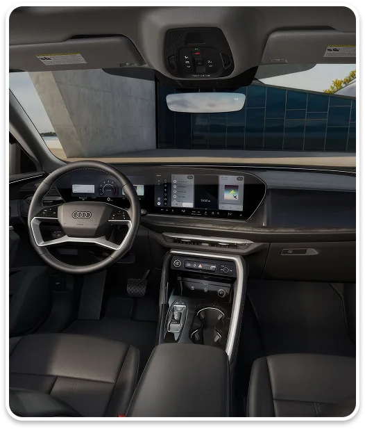 Audi Q5 cabin seen from the rear, with the steering wheel, displays and centre console