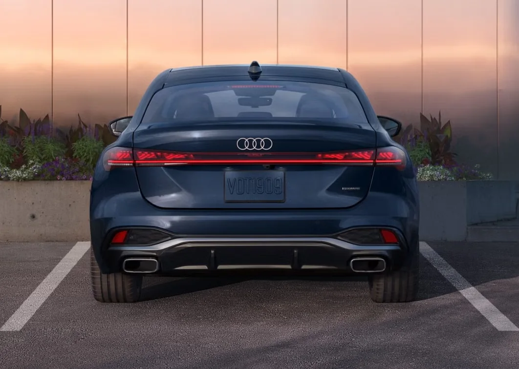 Rear view of a blue Audi A5 with its digital OLED taillights lit