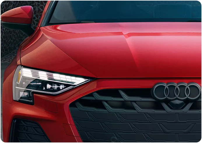 Close-up of the Audi A3 LED headlight, grille and Audi rings
