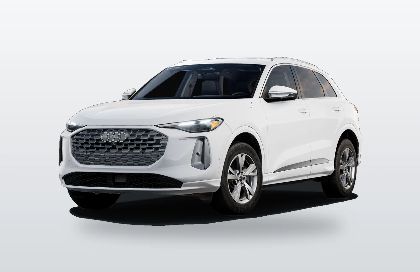 A white Audi Q5 SUV seen from the front three-quarter angle against a light gray studio backdrop