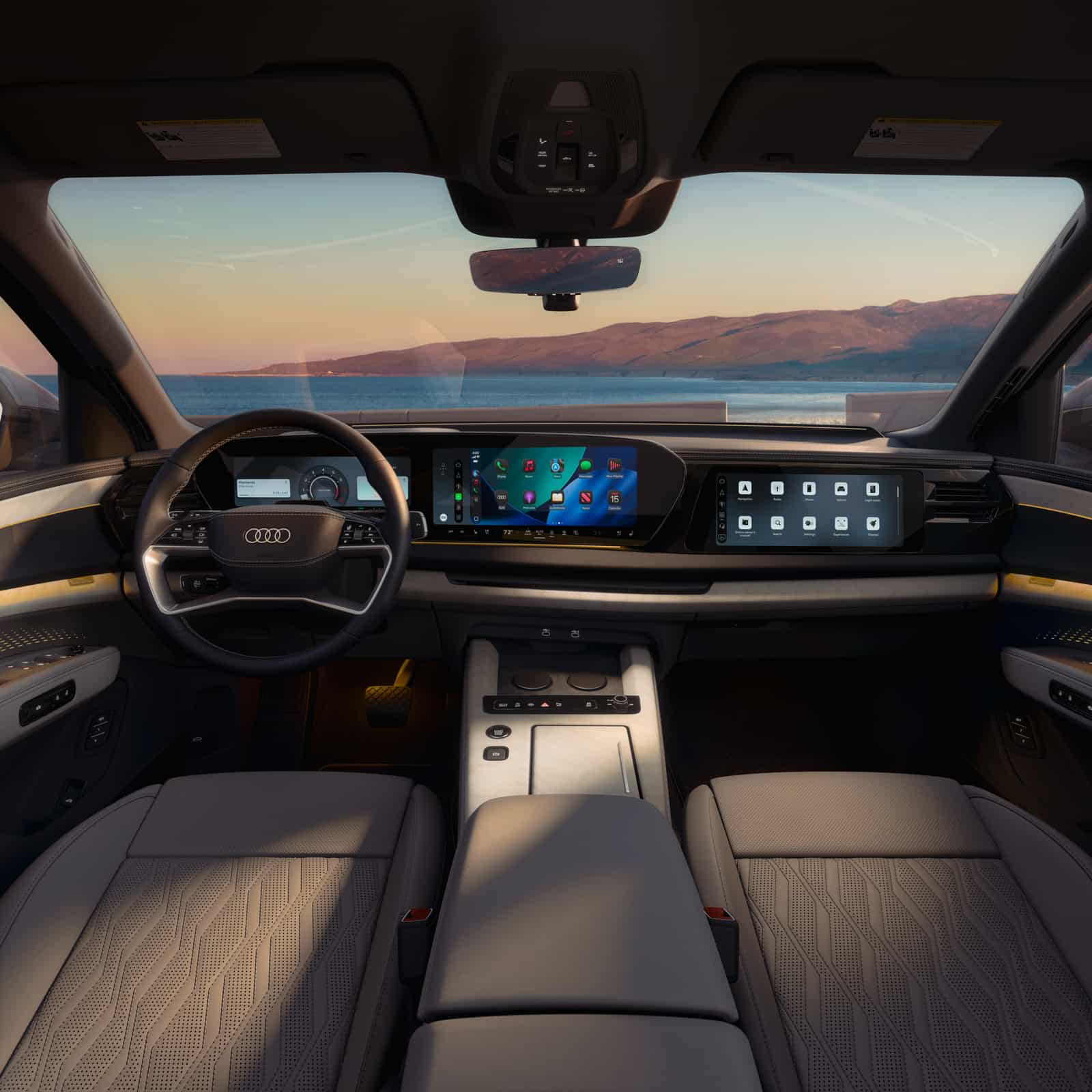 2027 Audi Q9 cockpit with the digital instrument cluster, curved MMI touchscreen, and passenger display
