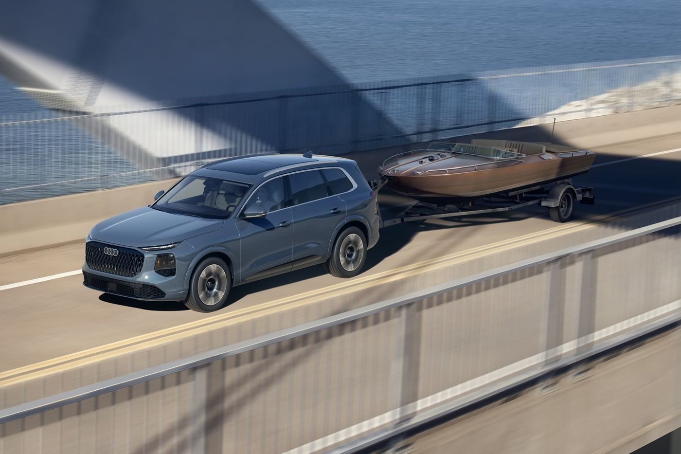 2027 Audi Q7 towing a boat on a bridge