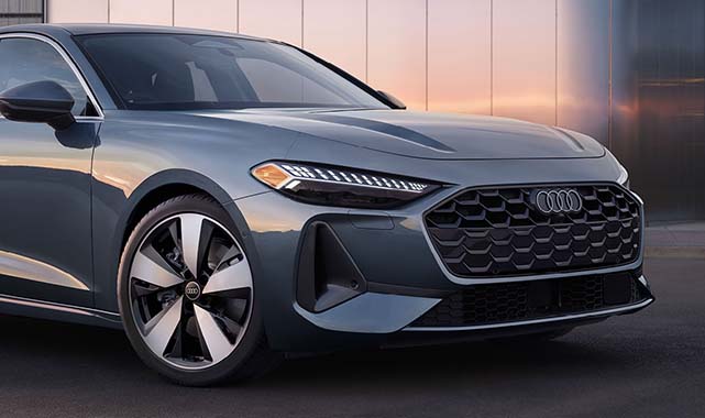 Close-up of the 2025 Audi A5’s front fascia, featuring sharp matrix LED headlights and a redesigned honeycomb grille.