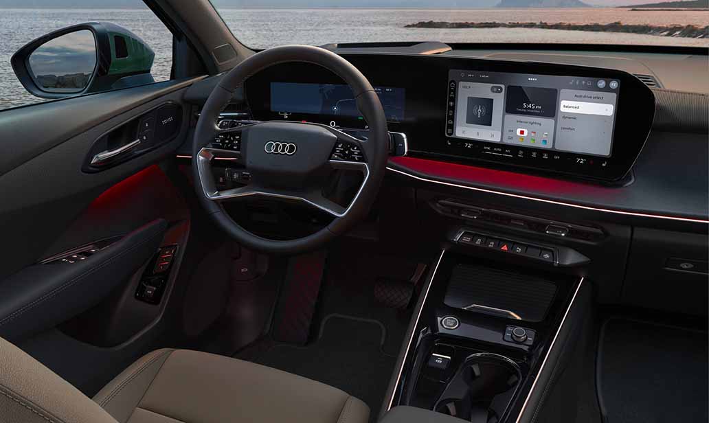 Audi Q3 cockpit view showcasing the digital driver display, premium steering wheel, and sleek infotainment system with coastal backdrop.