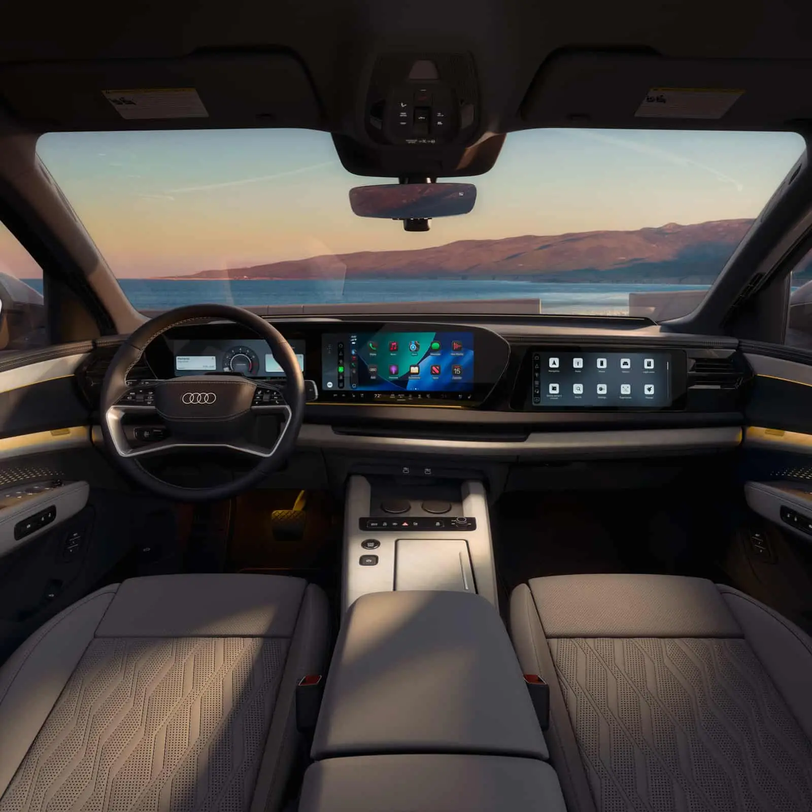 2027 Audi Q9 cockpit with the digital instrument cluster, curved MMI touchscreen, and passenger display