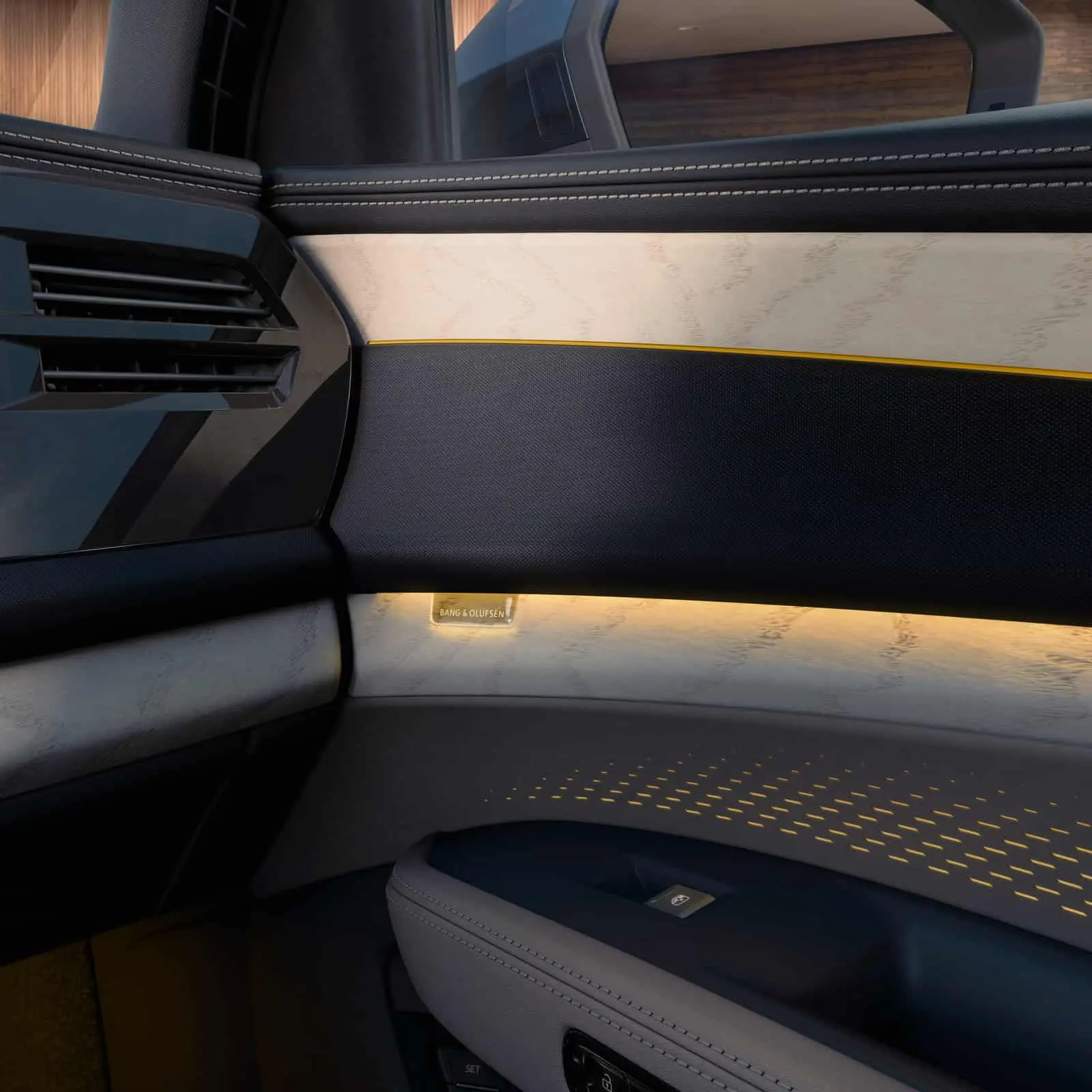 2027 Audi Q9 door panel with wood inlay, ambient lighting, and a Bang & Olufsen speaker grille
