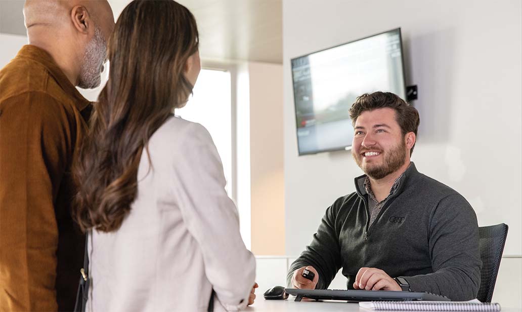 Man and woman talking to salesperson