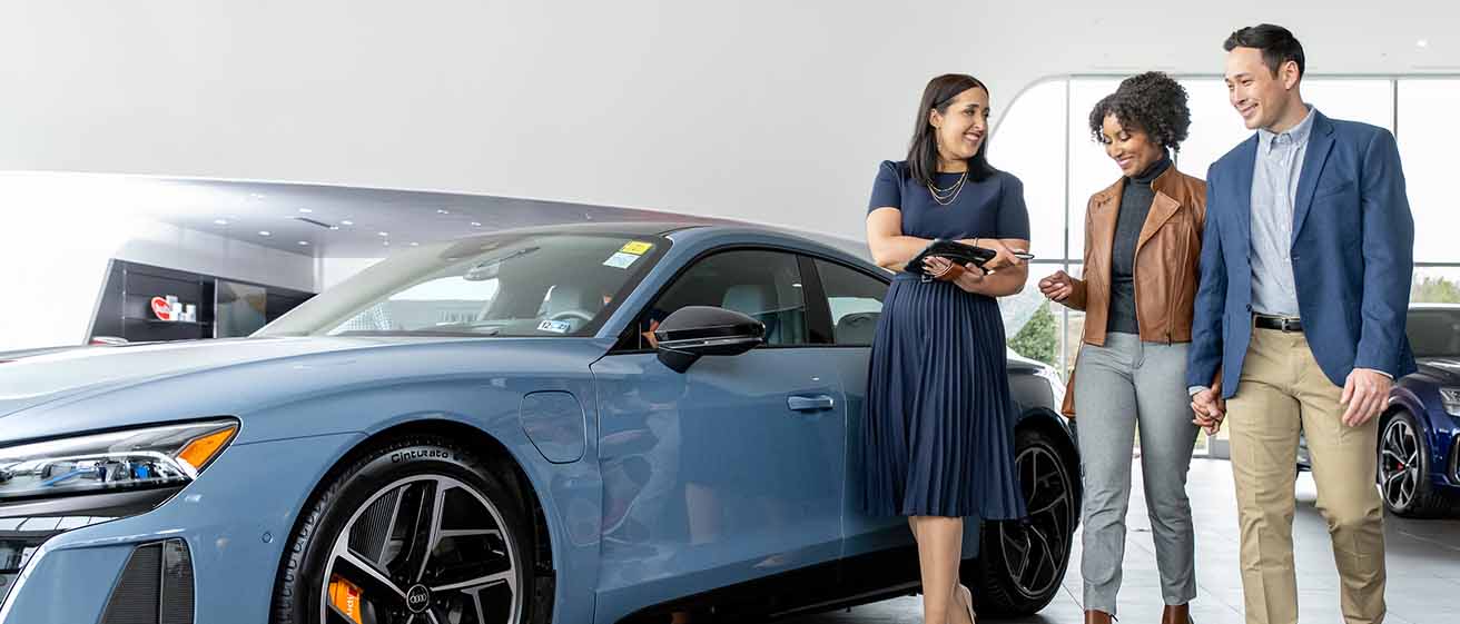 Young couple being shown around by a Audi Wesley Chapel sales consultant