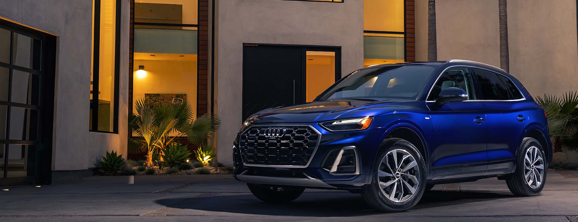 Audi Q5 parked beside modern home