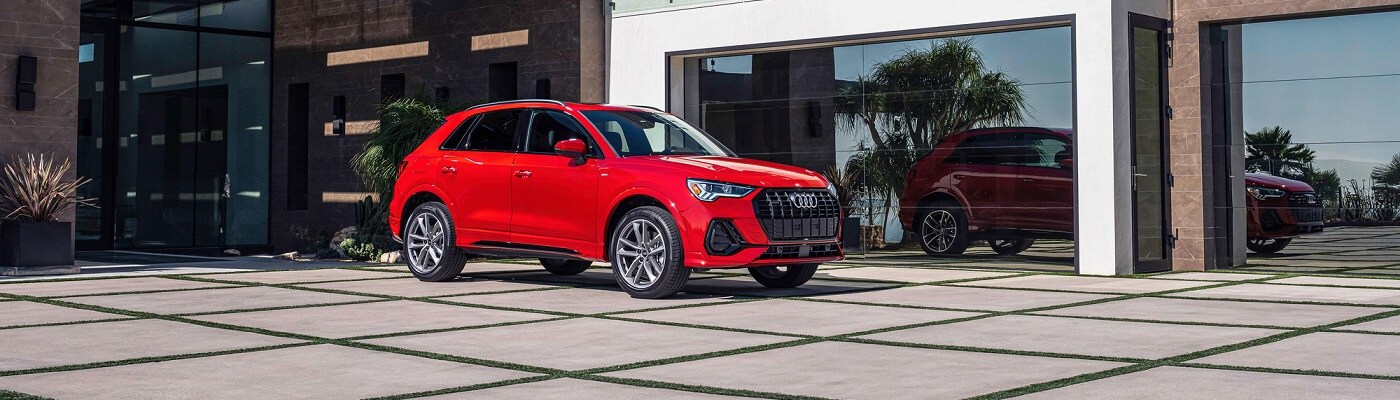 Audi Q3 Red Audi Q3 S-Line parked by a modern house
