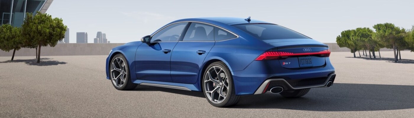 Audi RS 7 Blue Audi RS 7 parked between small trees overlooking city buildings