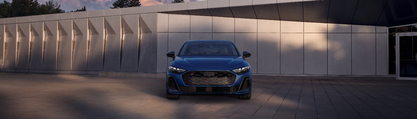 Audi S5 Cabriolet Blue Audi S5 Sportback parked next to building with angular siding