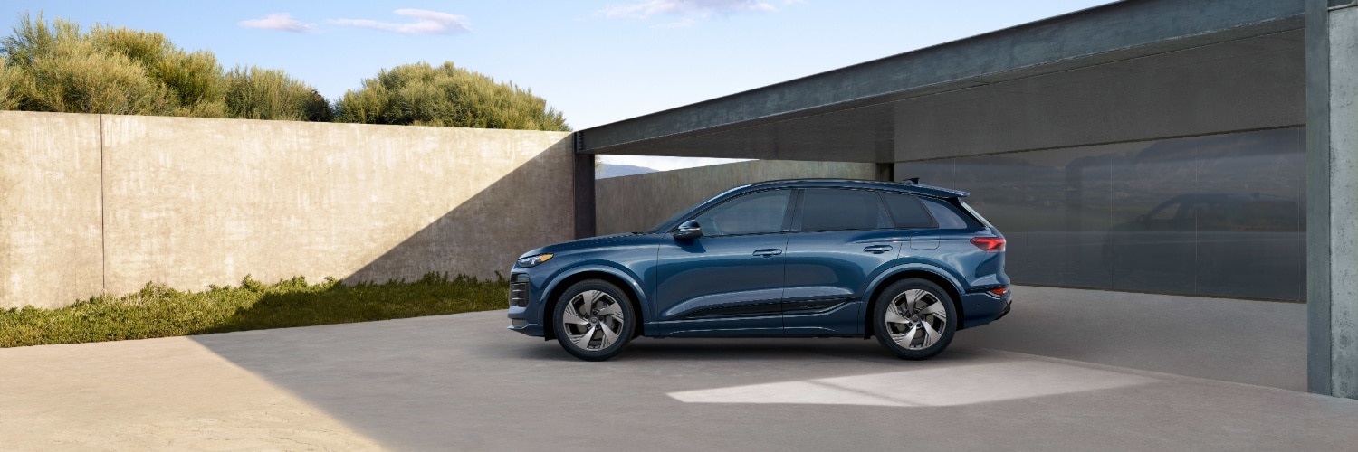 Audi Q6 e-tron Audi Q6 e-tron parked near a concrete wall
