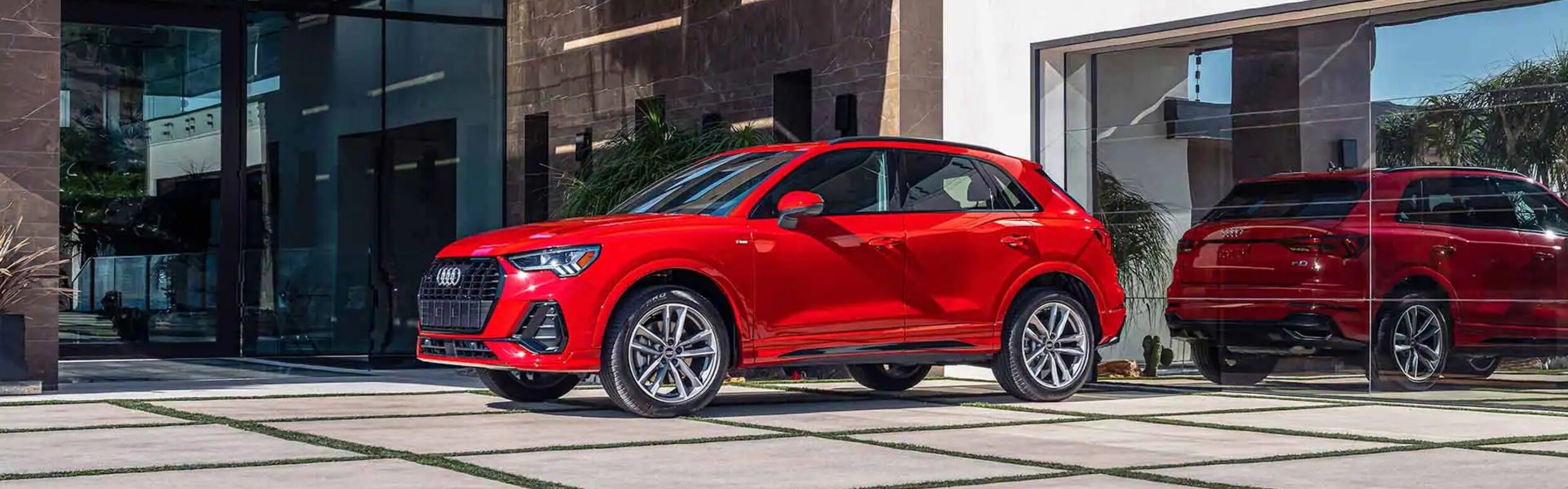 Audi Q3 tang red sideview parked.jpg