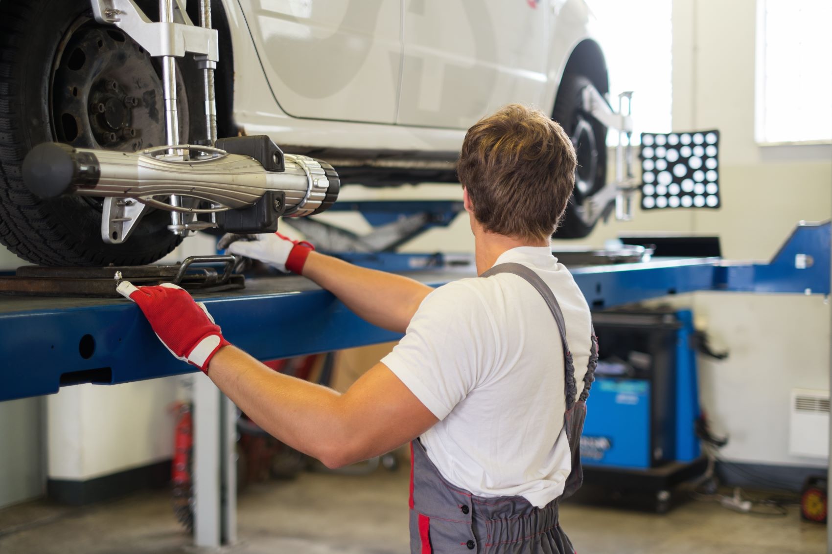 Technician Checking Wheel Alignment