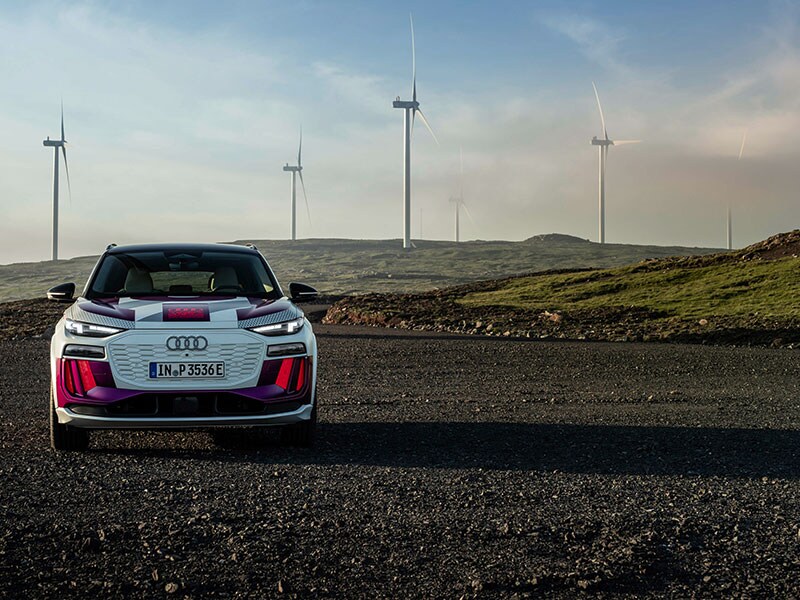 2023 Audi Q6 e-tron on road with windmills rear view