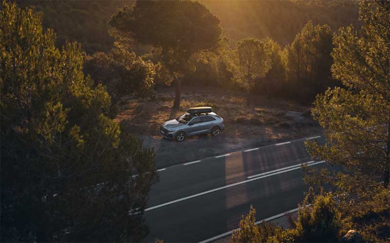 Audi with Roof Box driving on a road