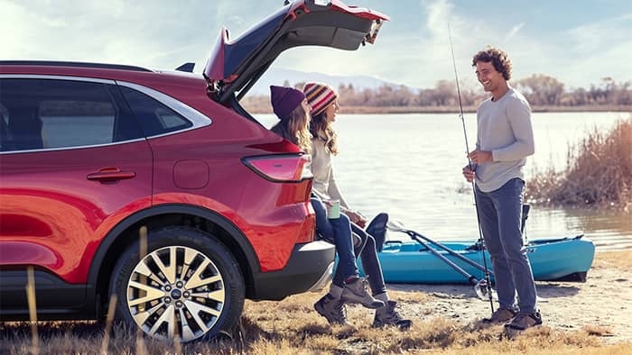 Friends by Ford Escape parked at Lake