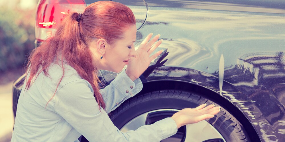 Woman Discovering Scratched Car