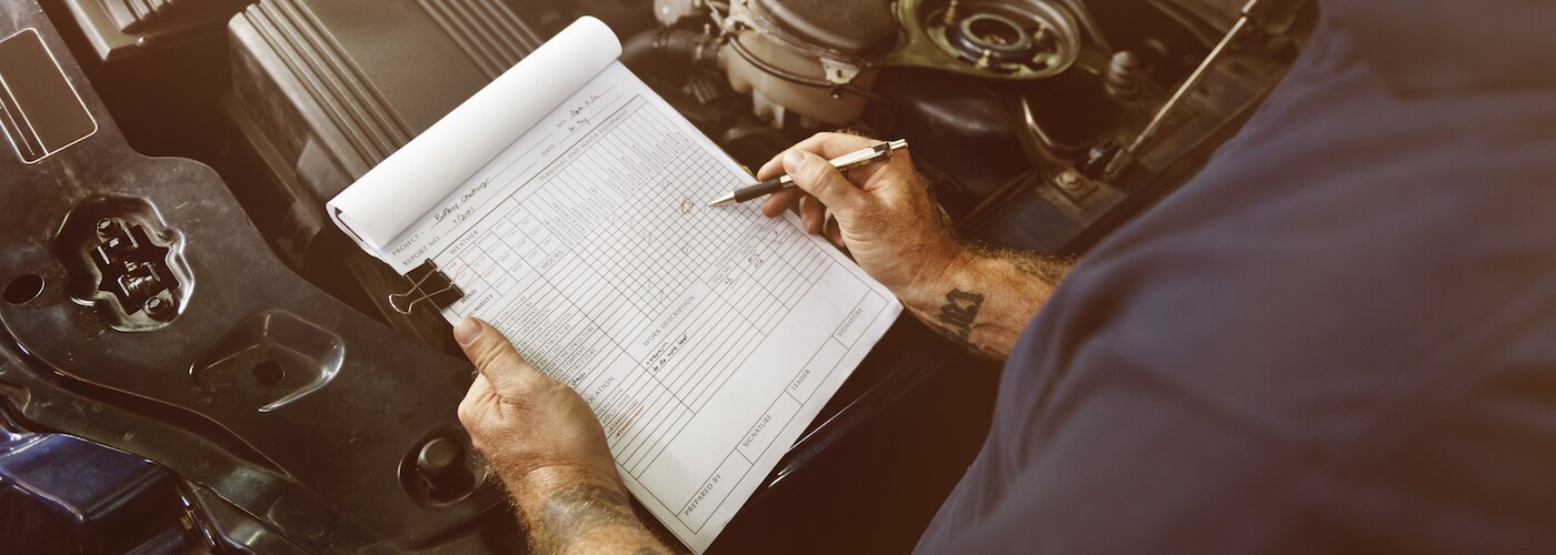 Mechanic Going Over Checklist