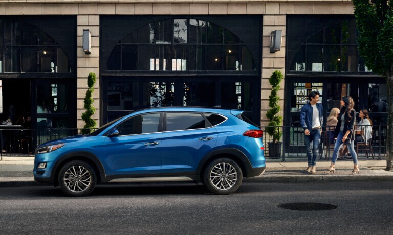 Couple walking to 2020 Hyundai Tucson parked on the street