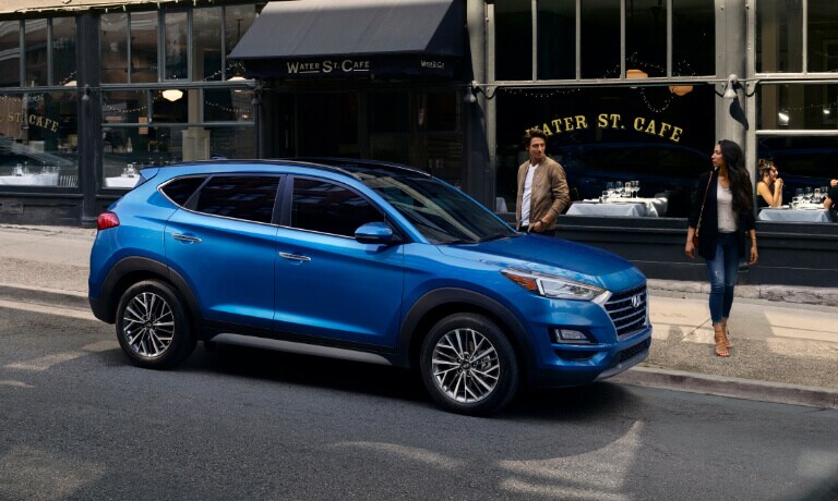 Couple walking to Blue 2020 Hyundai Tucson