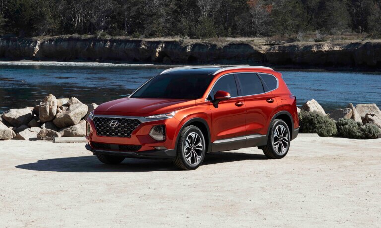 Orange 2020 Hyundai Santa Fe parked by a lake