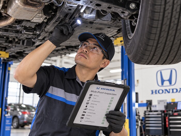 Honda technician performing a multi-point inspection